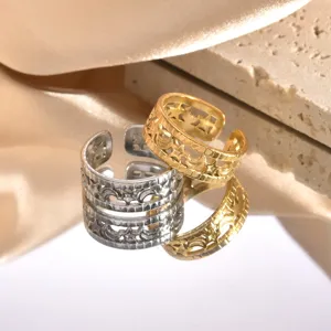 Close-up detail of stainless steel open rings featuring hollow star and moon geometric patterns.