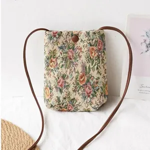 Floral tapestry mini crossbody bag detail, vintage floral pattern shoulder bag close up.