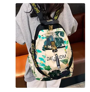 Detail view of the floral print oxford cloth backpack with shoulder straps and zipper pockets.