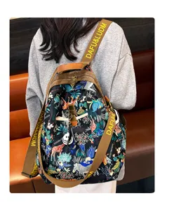 Detail view of a stylish women's printed tropical backpack with adjustable brown straps.