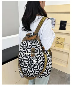 Chic black and white geometric oxford fabric backpack with brown straps for casual daily commute.