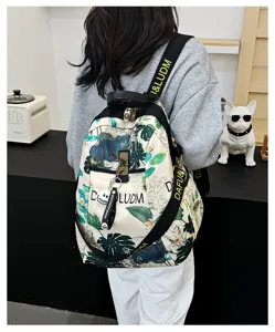 Detail view of botanical print women's Oxford backpack, showing strap design and back wear.