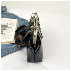 Retro PU leather kiss-lock shoulder bag, side view showing detailed metal frame and chain strap.