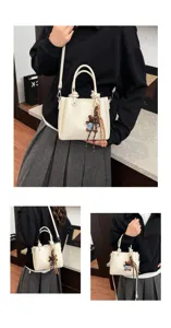 Women white soft leather bucket bag with cute bear pendant, versatile shoulder crossbody.