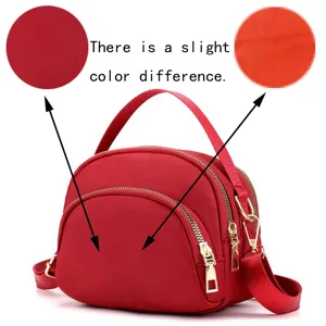 Mini red nylon shell crossbody bag for women, lightweight commuting shoulder bag with zippers.