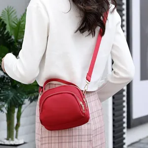Red nylon mini shell crossbody bag, showcasing detailed back view and adjustable strap.