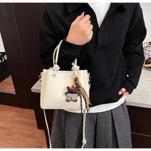 Korean style soft leather bucket bag with cute bear pendant, versatile shoulder crossbody bag.