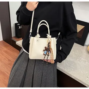 White bucket bag for women, stylish soft leather shoulder bag with cute bear charm.