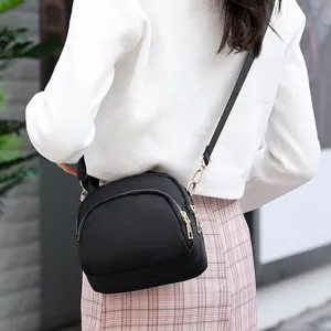 Black nylon crossbody shoulder bag detail, compact lightweight daily commuter phone purse