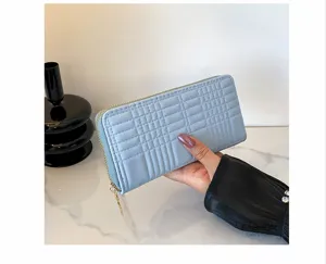 Detailed view of women's long zipper wallet with stylish embossed pattern, large capacity.
