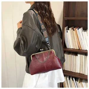 Retro kiss-lock PU leather shell shoulder bag with metallic chain and wide strap design.