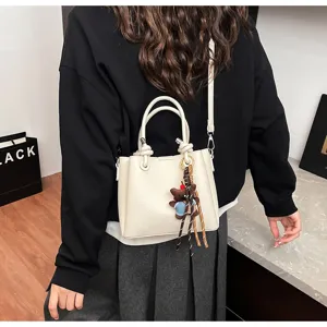 Korean style soft leather bucket bag with cute bear pendant and versatile shoulder strap.
