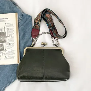 Vintage kiss-lock shell bag detail, dark green PU leather, chic chain handle and ethnic strap.