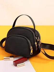 Mini nylon dome crossbody bag for women, lightweight black shoulder bag, daily commuting.