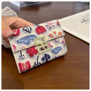 Close-up detail of a cute floral print PU leather card holder, compact folding wallet.