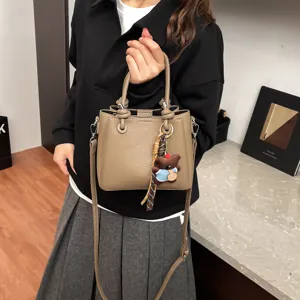 Korean style PU leather bucket bag with cute bear pendant, versatile shoulder crossbody bag.