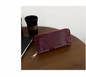 Elegant women's long snake print wallet with secure zip-around closure and premium texture.