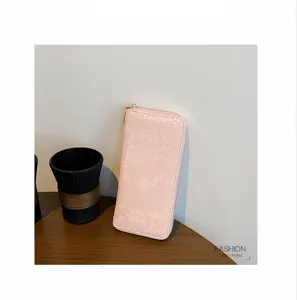 Pink snakeskin long zip wallet detail view, elegant ladies purse with multiple card slots.