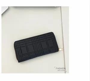 Detailed view of the black quilted long zip wallet showing premium texture and stitching.