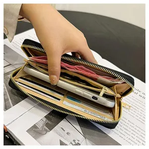 Primo piano dettagliato di un portafoglio nero con zip che mostra fessure e spazio per telefono.
