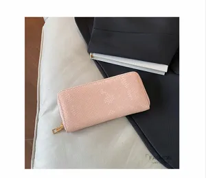 Elegant pink snakeskin long wallet for women, stylish evening clutch with zipper and cards slots.