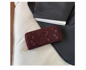 Elegant women snake print long wallet with large capacity zip design for evening and daily use.