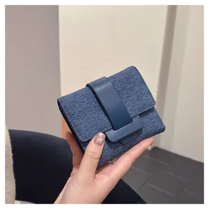 Detailed view of women denim short wallet with leather buckle closure, compact card holder.