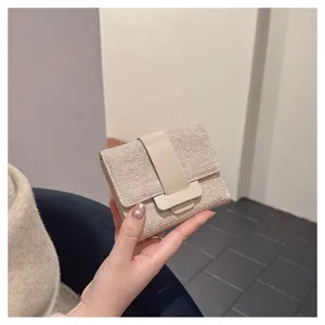 Compact women trifold wallet with leather strap closure, portable small card holder purse design.