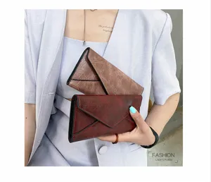 Details of retro soft leather long wallet, envelope tri-fold design with geometric texture.