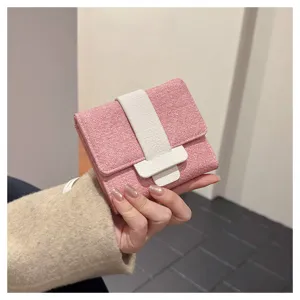 Compact pink trifold wallet featuring a stylish white leather buckle for daily women use.