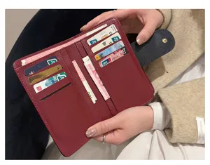 Gros plan d'un portemonnaie court pour femme en cuir PU bordeaux avec fentes pour cartes.