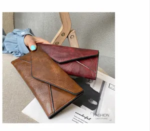 Vintage long wallet for women, soft leather clutch purse with multiple card slots and tri-fold design.