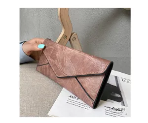 Close up view of retro soft leather long envelope wallet with vintage textured design.