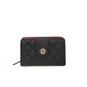Portefeuille court matelassé noir pour femme avec fermoir doré et doublure rouge vue principale.