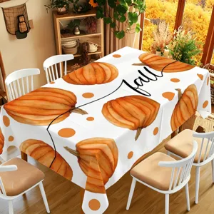 Fall pumpkin tablecloth detail showcasing warm Thanksgiving dining room decor and festive vibes.
