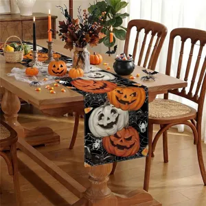 Halloween table runner with scary pumpkin prints for spooky dining room holiday party decor.