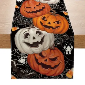 Halloween table runner detail shot featuring spooky jack-o'-lantern pumpkins and spider web print.