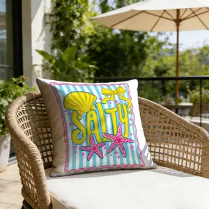 Coastal theme pillow detail featuring blue stripes, yellow shell and pink starfish.