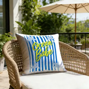 Closeup of resort style striped starfish pattern pillow cover in outdoor patio scene.