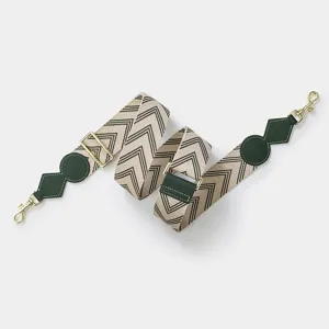 Adjustable wide replacement bag strap with chevron pattern and dark green leather details.