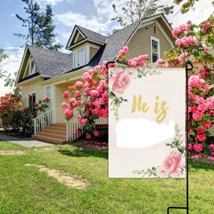 Easter garden flag detail showcasing pink rose floral pattern and religious holiday decoration outdoors.