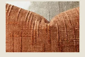 Nahaufnahme der strukturierten Kissenbezug-Oberfläche aus weichem Chenille in Rostbraun.