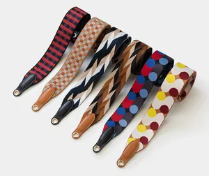 Colorful patterned replacement bag straps with leather ends and metal rings for handbags.
