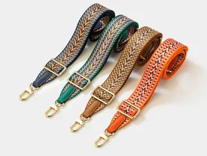 Adjustable woven replacement bag strap with chevron pattern and gold hardware for bags.