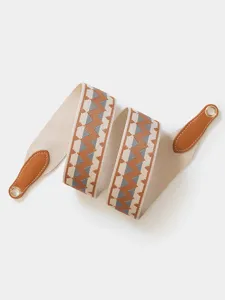 Wide woven replacement shoulder strap with geometric pattern and leather ends for bags.