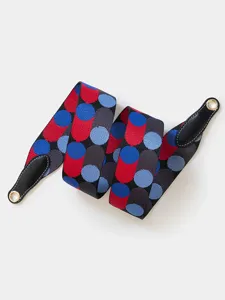 Detailed view of wide replacement bag strap featuring colorful geometric dots and leather ends.