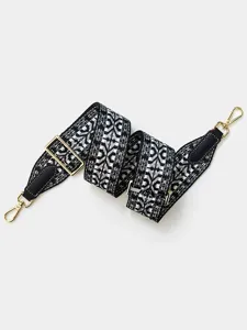 Detailed shot of black and white geometric woven replacement bag strap with gold hardware.