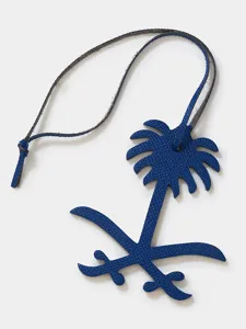 Blue leather palm tree charm detail view, elegant bag pendant and key ring accessory.