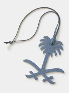 Blue leather palm tree charm detail, stylish luxury bag pendant and car key accessories.
