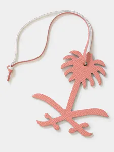 Pink leather palm tree bag charm luxury key ring pendant detailed close-up display.